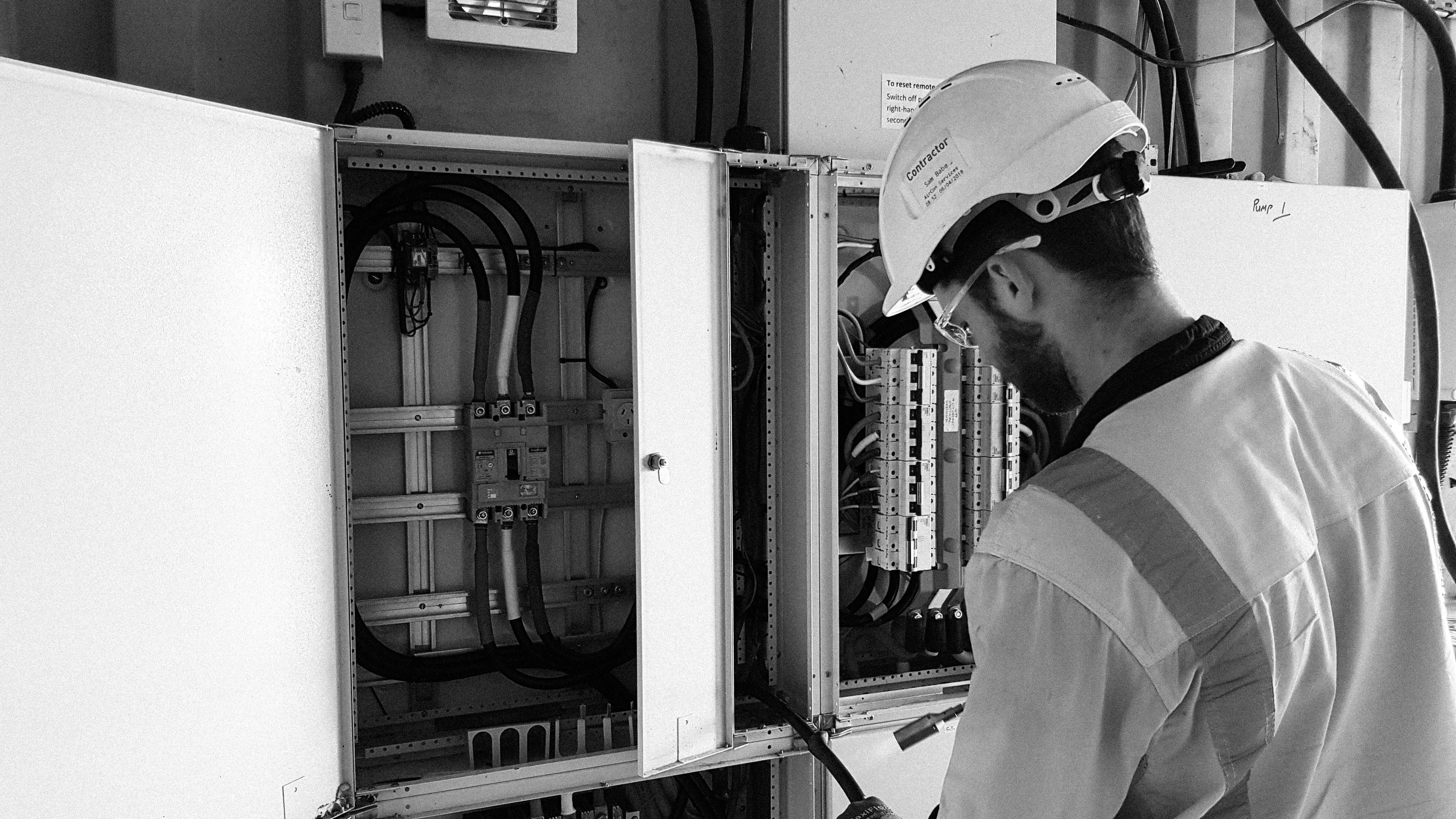 Electrician working on an open switchboard