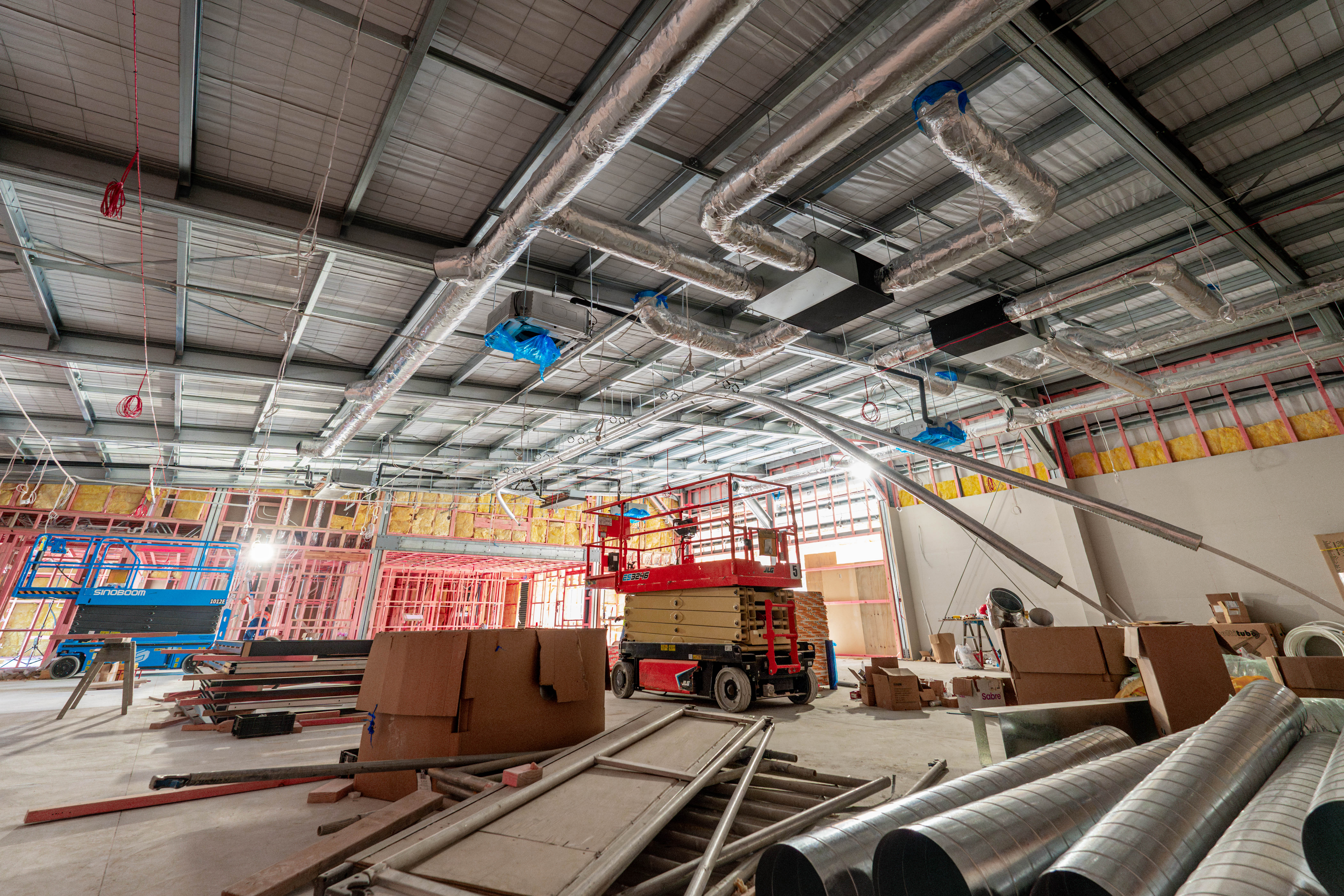 Ductwork installed from a scissor lift inside the warehouse