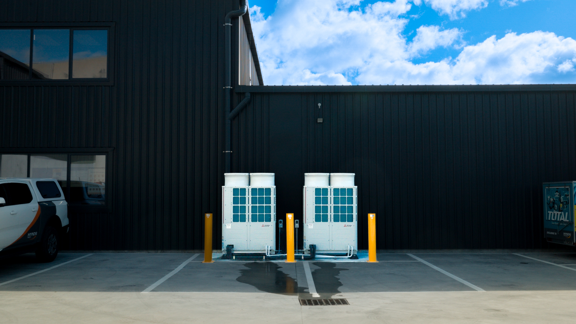 Twin VRF outdoor units against a blue sky