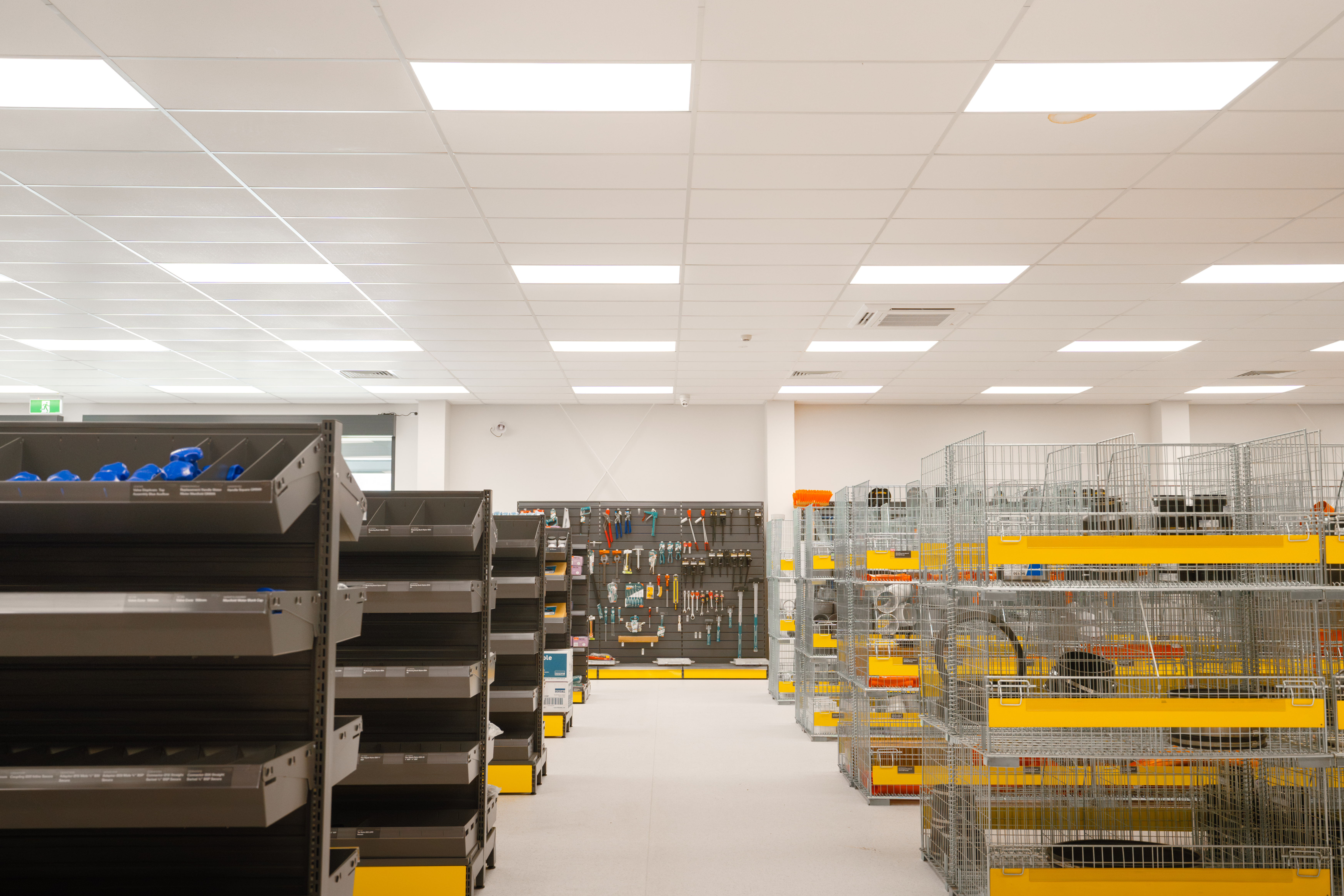 Trade store aisle with shelving and a tool wall